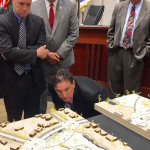Mayor Bevis gets down low to inspect some of the more intricate details of the USF group's concept.