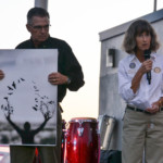 Craig and Toni Gross speak at the Oldsmar mural unveiling on Veterans Day. Frank is holding his son, Frank's, artwork that is depicted on the mural.