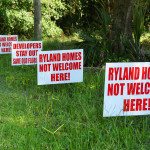 These anti-development signs can be seen all around the area.