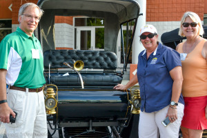 R.E. Olds' great-granddaughter, Debbie Stephens (R) poses with her husband, Peter, and Becky Afonso during the Centennial Classic Car Show in downtown Oldsmar Friday night.