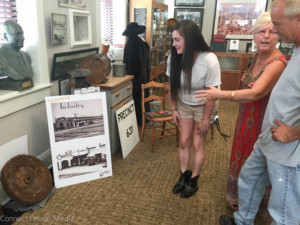 Jeri Antozzi shows the flywheel to Eric Ramquist and Elizabeth Lyons on Tuesday afternoon.