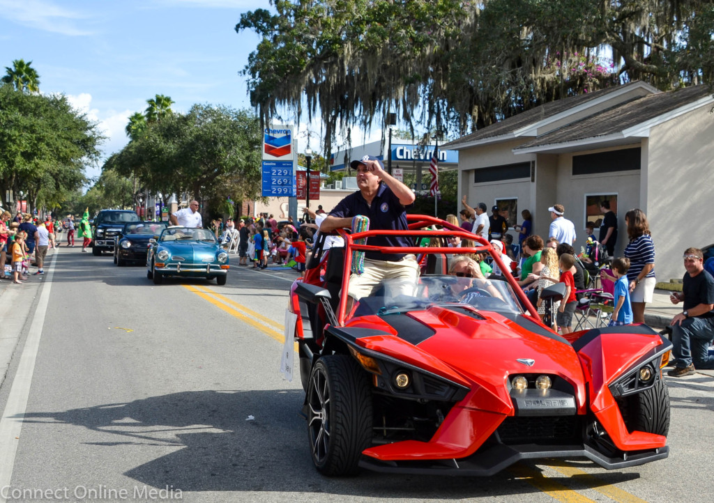 Oldsmar Mayor Dog Bevis throws beads to the crowd during the Safety Harbor Holiday Parade on Saturday, Dec. 17, 2016.
