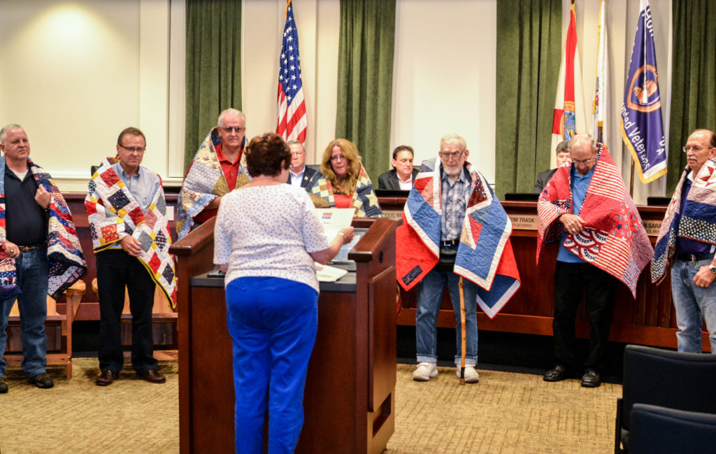Ginger Messer from the Tampa branch of the Quilts of Valor Foundation presented seven military service members with custom-made quilts during the Oldsmar City Council meeting on Dec. 6, 2016.